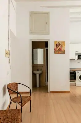 a kitchen with a table and a chair in a room at BELLAFILA GOTHIC in Barcelona