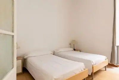 two beds in a room with white walls at BELLAFILA GOTHIC in Barcelona