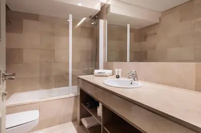 a bathroom with a sink and a tub and a mirror at Passeig de Gràcia by Enjoybcn in Barcelona