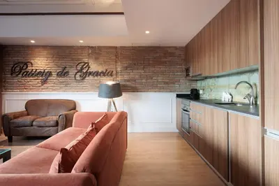 a living room with a couch and a kitchen at Passeig de Gràcia by Enjoybcn in Barcelona