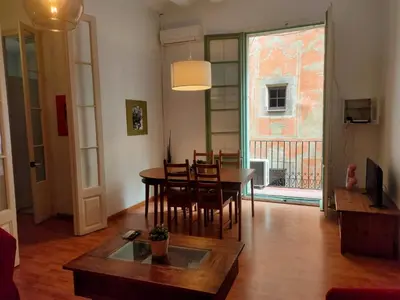 a living room with a table and chairs and a dining room at Esparteria 1 in Barcelona