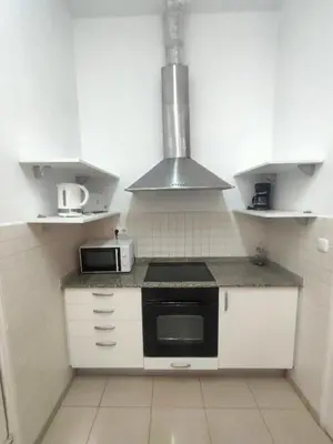 a small kitchen with a stove and a microwave at Esparteria 1 in Barcelona