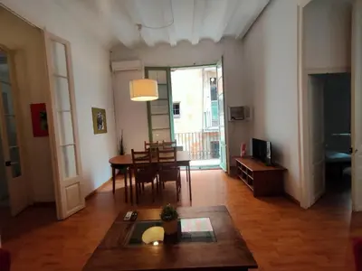 a living room with a table and a dining room at Esparteria 1 in Barcelona