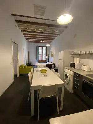 a kitchen with a white table and chairs in a room at Esparteria 2 in Barcelona