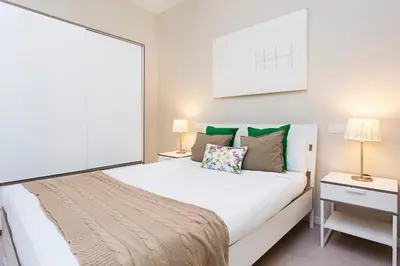 a bedroom with a large white bed and two lamps at Stay U-nique Apartments Floridablanca II in Barcelona