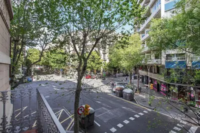 an empty city street with a tree and buildings at Stay U-nique Apartments Floridablanca II in Barcelona