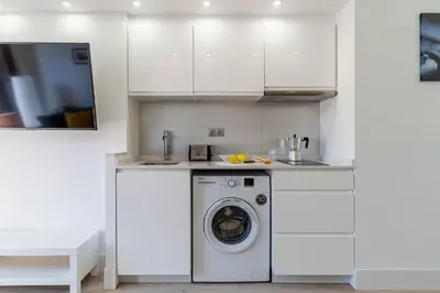 a white kitchen with a washing machine in it at 236 - AB Poble Sec Montjuic in Barcelona
