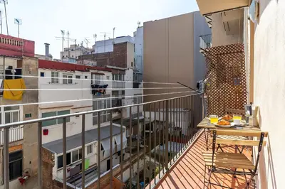 a balcony with a table and a view of a city at 236 - AB Poble Sec Montjuic in Barcelona