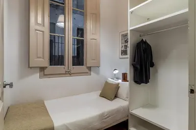 a small room with a bed and a window at AB Bailen Apartments in Barcelona