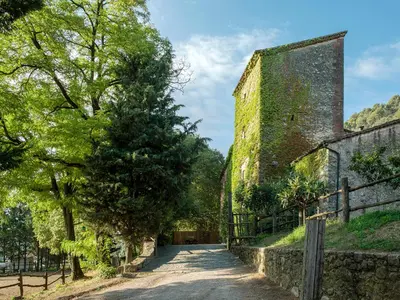 an alleyway next to a building with a tower at Les Canes in Aiguafreda