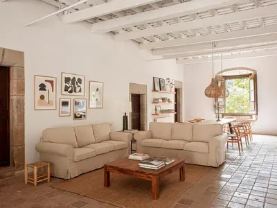 a living room with two couches and a table at Les Canes in Aiguafreda