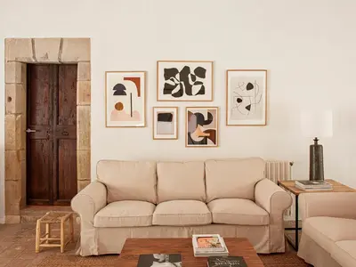 a living room with a couch and pictures on the wall at Les Canes in Aiguafreda