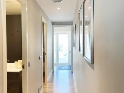 a hallway leading to a bathroom with a sink at Sitges Spaces Bonaire Penthouse in Sitges
