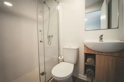 a bathroom with a toilet and a sink and a shower at Tres Estrellas Barcelona by HolaCamp in Gavà
