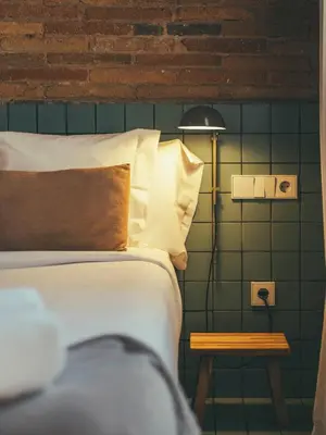 a bedroom with a bed and a table with a lamp at Boutique Apartments 23 Barcelona in Barcelona