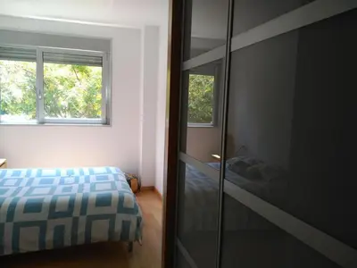 a bedroom with a bed and a glass closet at 2 BEDROOMS and 2 BATHROOMS FOR 5 PAX, SWIMMING POOL, FREE PARKING and NEAR THE BEACH! in Sant Adria de Besos
