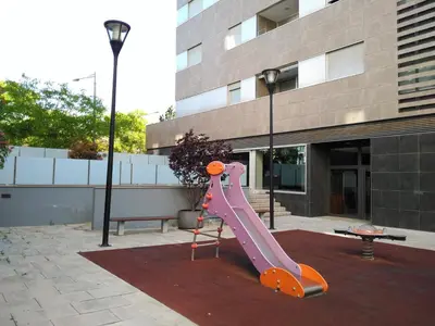 a purple slide in front of a building at 2 BEDROOMS and 2 BATHROOMS FOR 5 PAX, SWIMMING POOL, FREE PARKING and NEAR THE BEACH! in Sant Adria de Besos