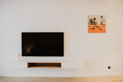 a flat screen tv sitting on a white wall at Petit Luxe St. Pere in Terrassa