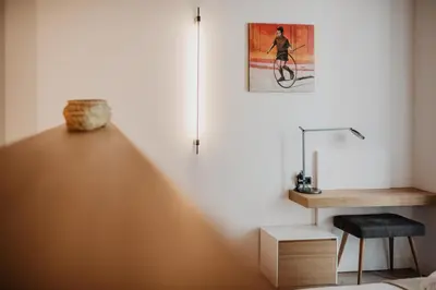 a room with a desk and a picture on the wall at Petit Luxe St. Pere in Terrassa