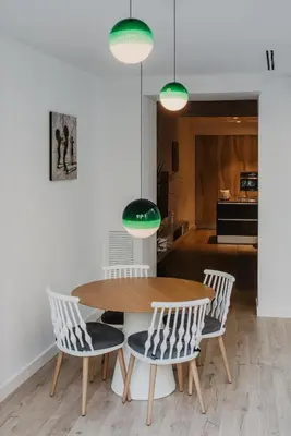 a dining room with a wooden table and chairs at Petit Luxe St. Pere in Terrassa