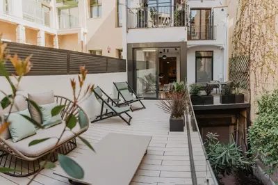 a patio with chairs and plants on a building at Petit Luxe St. Pere in Terrassa