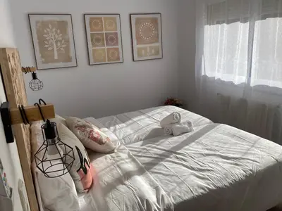 a bedroom with a bed with white sheets and pillows at Vilamarlux VI in Vilassar de Mar