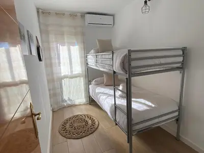 a bedroom with two bunk beds in a room at Vilamarlux VI in Vilassar de Mar