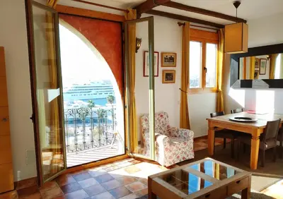a living room with a large window and a table at Barceloneta Ramblas Apartments in Barcelona