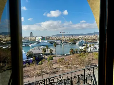a view of a harbor from a window at Barceloneta Ramblas Apartments in Barcelona