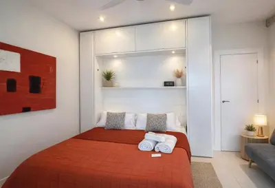 a bedroom with a bed with towels on it at Colom Apartment 3BR with Balcony & Port Vell Views in Barcelona
