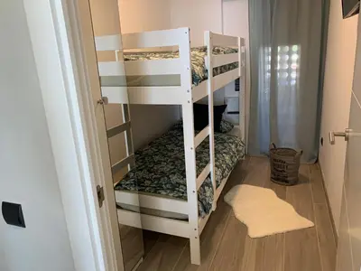 a room with two bunk beds in a room at Formentor in Castelldefels