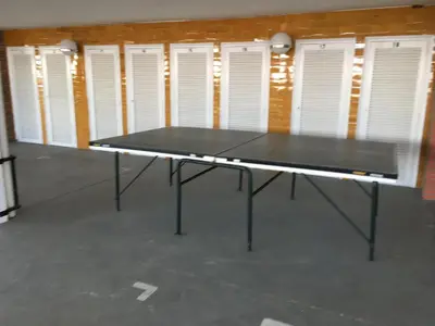 a ping pong table in a room with white doors at Formentor in Castelldefels
