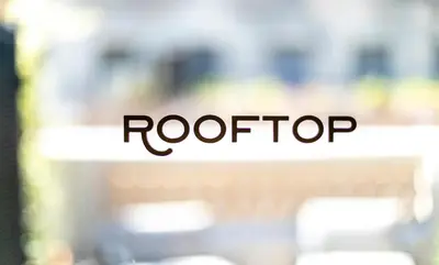 a bench with the word roof top written on it at Hotel Casa Sagnier in Barcelona