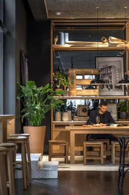 a man sitting at a table in a restaurant at Hotel Casa Sagnier in Barcelona