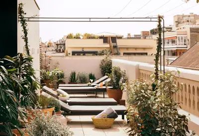a balcony with chairs and plants on a building at Hotel Casa Sagnier in Barcelona