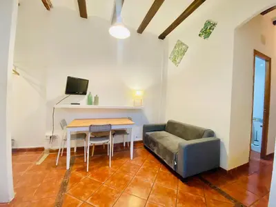 a living room with a couch and a table at 03 cozy barça 2,1 in Barcelona