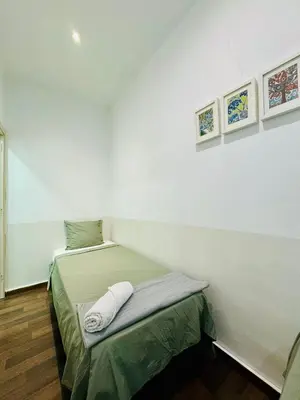 a small bed in a room with white walls at 028 Apartament 2 2 in Barcelona