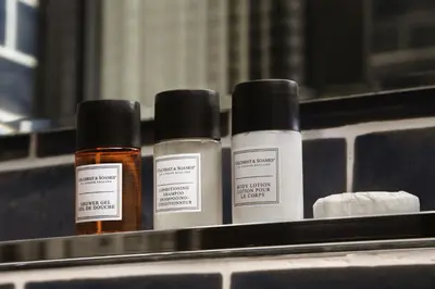 three bottles of essential oils sitting on a shelf at Praktik Bakery in Barcelona