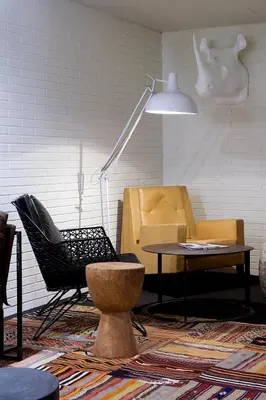 a room with two chairs and a table and a lamp at Praktik Bakery in Barcelona