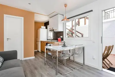 a kitchen and living room with a table and chairs at Cozy&new With Terrace in Hospitalet de Llobregat