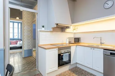 a kitchen with white cabinets and a sink at Apartamento Clsico Con Terraza in Barcelona