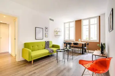 a living room with a green couch and a table at Colorful With Cozy Terrace In Gracia in Barcelona