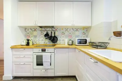 a white kitchen with white cabinets and a sink at Colorful With Cozy Terrace In Gracia in Barcelona
