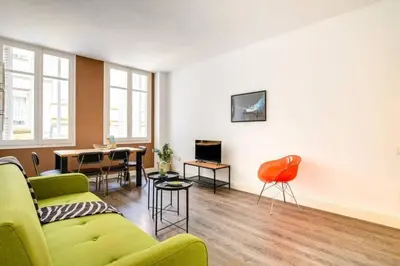a living room with a couch and a table at Colorful With Cozy Terrace In Gracia in Barcelona