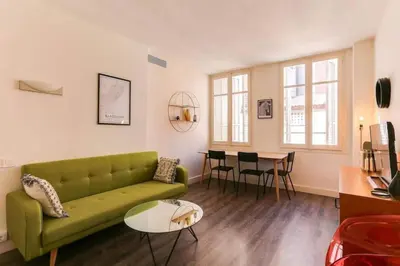 a living room with a green couch and a table at Stylish 2 Bdr In Trendy Gracia in Barcelona