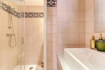 a bathroom with a shower and a tub and a sink at Stylish 2 Bdr In Trendy Gracia in Barcelona