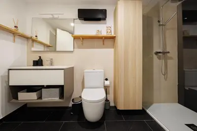 a bathroom with a toilet and a sink and a shower at Atico duplex Playa Area barcelona con SPA exterior in Montgat