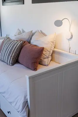 a white bed with pillows on top of it at Atico duplex Playa Area barcelona con SPA exterior in Montgat