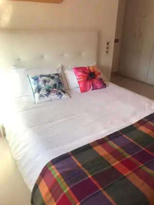 a large white bed with two pillows on it at Gran apartamento de 4 habitaciones en Sitges in Sitges