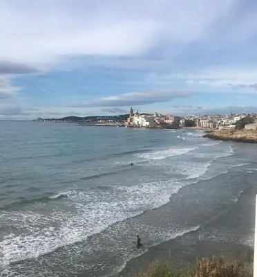 a person standing in the water at the beach at Gran apartamento de 4 habitaciones en Sitges in Sitges